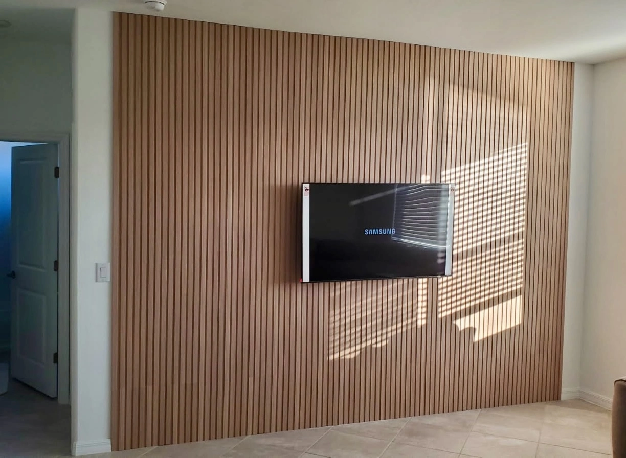 Custom slatted wood accent wall with TV mount Naples FL by 6M Design